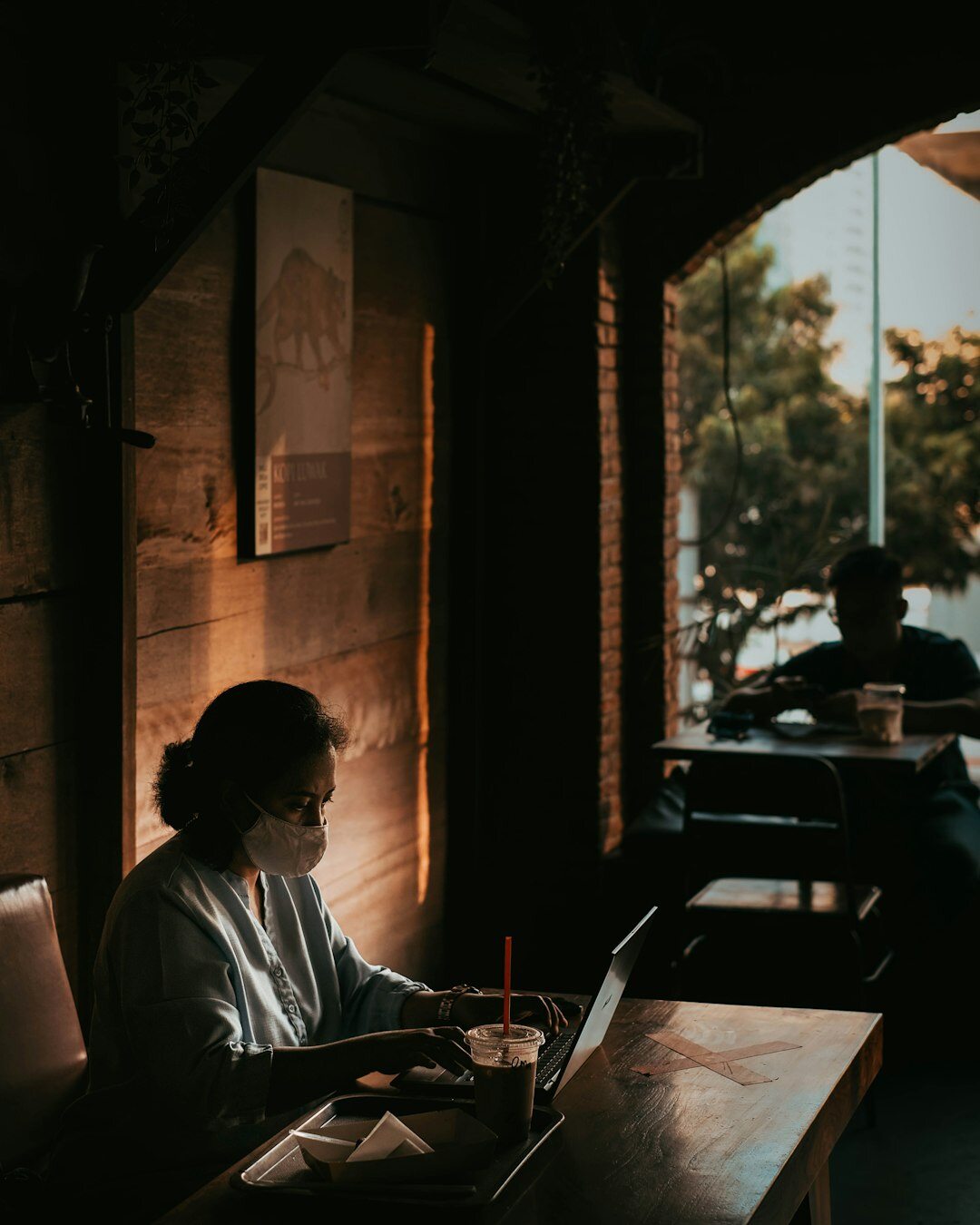 woman writing in cafe