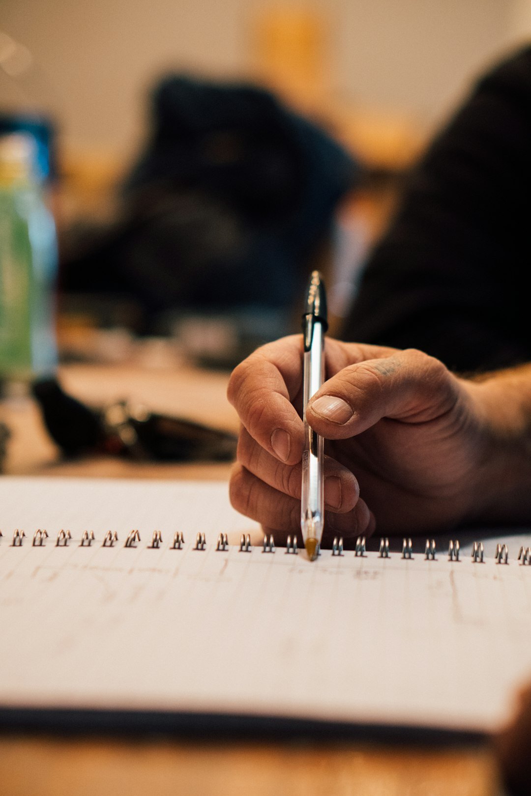 person writing in notebook